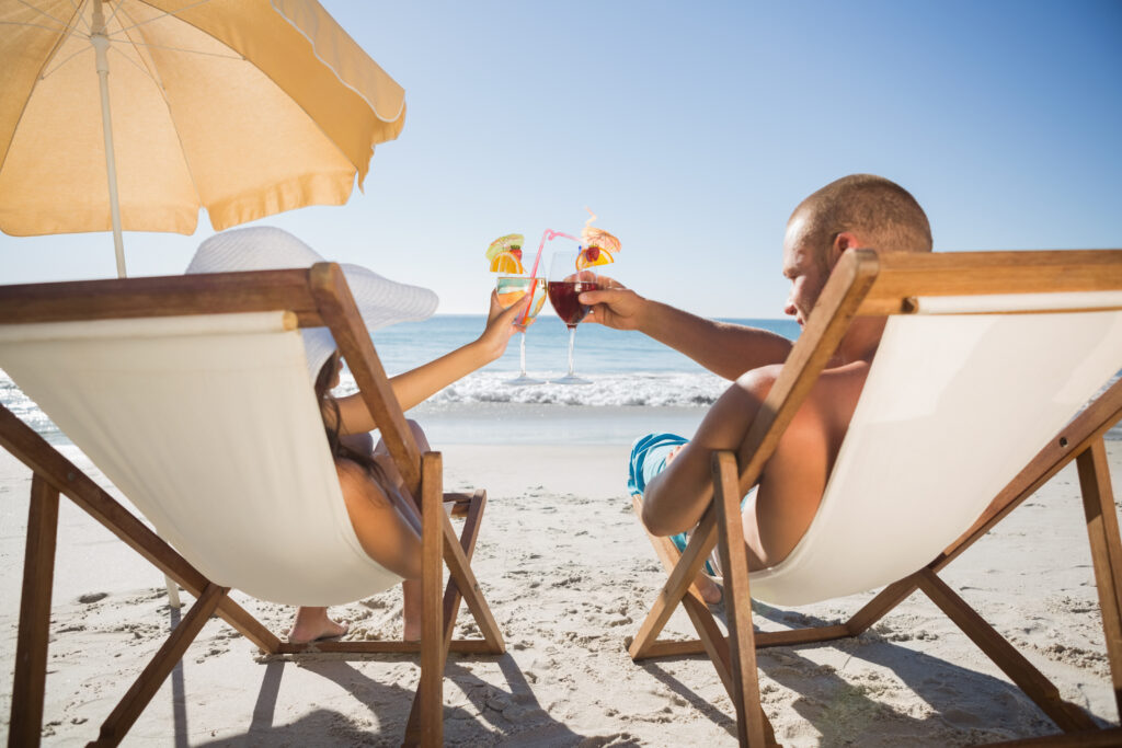 Couple enjoying drinks on the beach